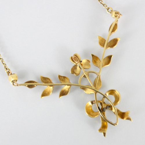 294 - An early 20th century yellow metal and seed pearl necklace, the foliate designed front with trefoil ... 