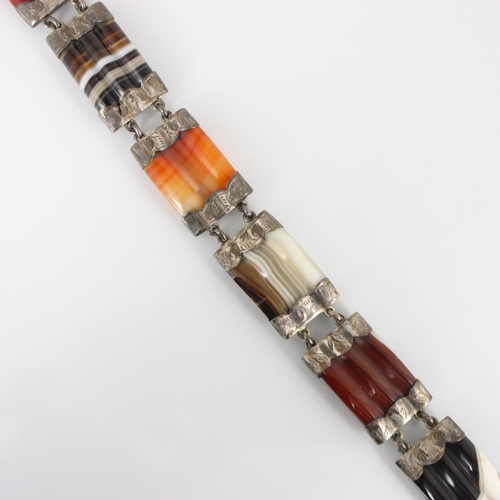 300 - A 19th century banded agate bracelet, the six rectangular panels of trefoil lobed detail, with white... 