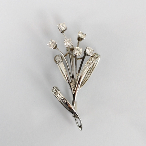 305 - A mid century diamond spray brooch, the six round cut diamonds above leaf designed detail set with s... 