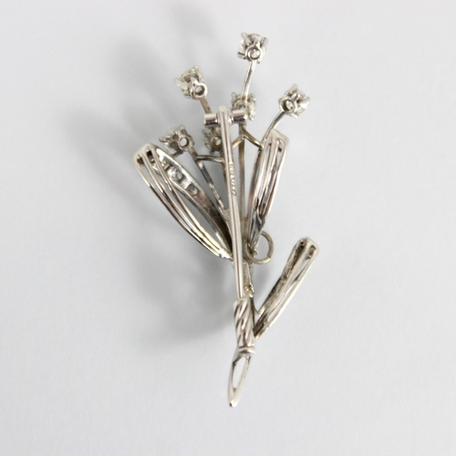 305 - A mid century diamond spray brooch, the six round cut diamonds above leaf designed detail set with s... 