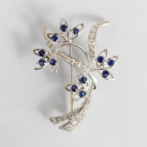 306 - A mid 20th century diamond and untested sapphire spray brooch, the flowerheads designed with triple ... 