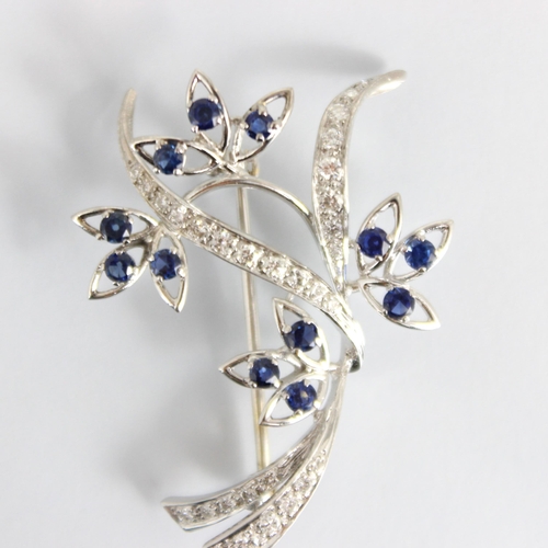 306 - A mid 20th century diamond and untested sapphire spray brooch, the flowerheads designed with triple ... 