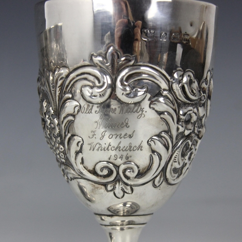 32 - An Edwardian silver goblet, possibly D and M Davis, Birmingham 1907, the fruit and foliate embossed ... 