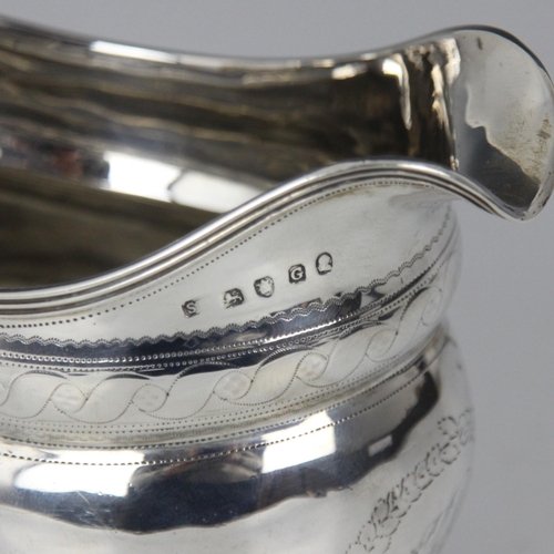 33 - A George III silver milk jug, indistinct makers mark, London 1802, the reeded rim above bulbous body... 