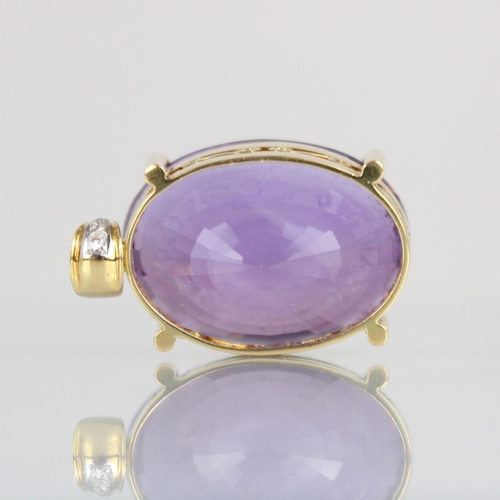 330 - An amethyst and diamond pendant, the oval cut amethyst within a yellow metal mount, with diamond set... 