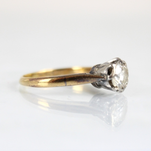 331 - A mid 20th century diamond solitaire ring, the round cut diamond within white metal illusion setting... 