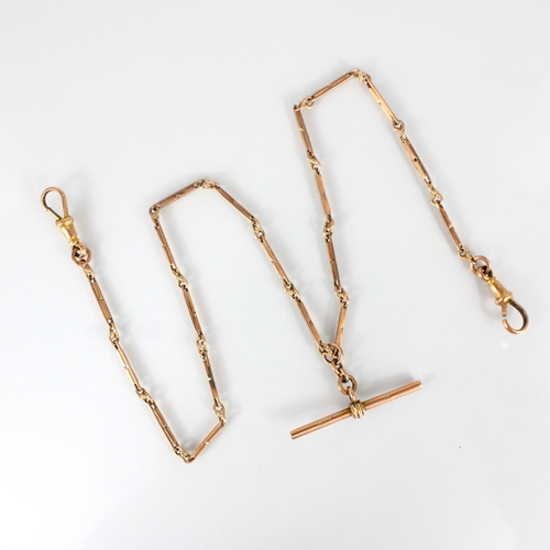 336 - An early 20th century yellow metal watch chain, the rectangular links with twisted link detail, susp... 