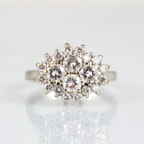 338 - An 18ct white gold diamond cluster ring, the central quatrefoil round cut diamonds within surround o... 