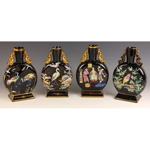 554 - A pair of Victorian Jetware moon flasks, each of typical form and decorated in polychrome enamel wit... 