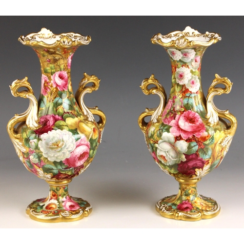 557 - A pair of late 19th century Copelands China 'Rococo' vases, each extensively painted in polychrome e... 