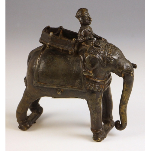 599 - An Indian bronze model of a elephant, mid 19th century, the caparisoned elephant modelled standing w... 