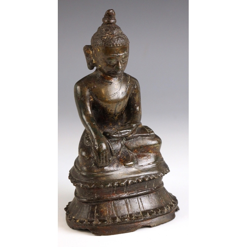 602 - A South-East Asian bronze model of a seated buddha, Nepal, 18th century, seated in dhyanasana with h... 