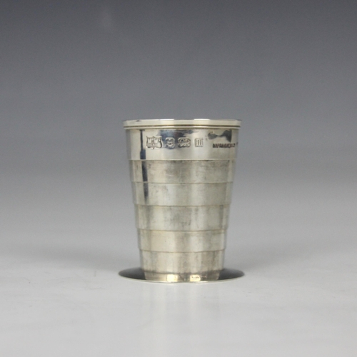 61 - A George V silver beaker, Mappin and Webb, Birmingham 1911, the collapsible tapered beaker with gilt... 