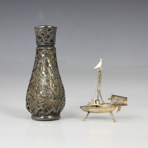 63 - A white metal mounted scent bottle, possibly Chinese, the baluster shaped bottle with white metal ov... 