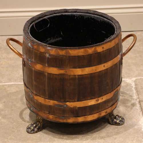 648 - A coopered oak log/coal bucket, of swelling form with a fitted metal liner, applied with four copper... 