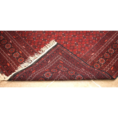 684 - A Caucasian Seychur type rug, in red, black and ivory colourways, the central field with an all over... 