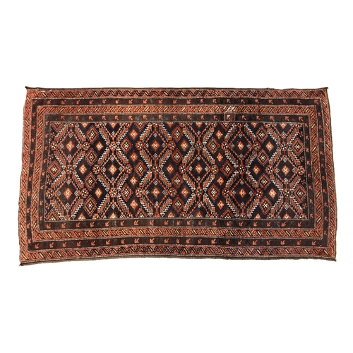 685 - A Baluchi pattern rug, in blue, brown and coral colourways, the central field with a all-over serrat... 