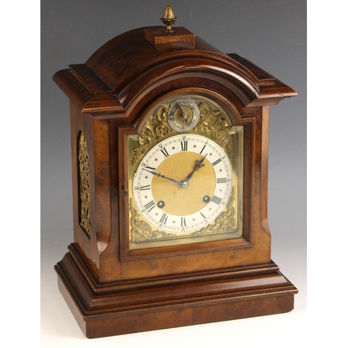 710 - A German walnut cased bracket clock, by Mathias Bauerle, late 19th/early 20th century, the arched ca... 