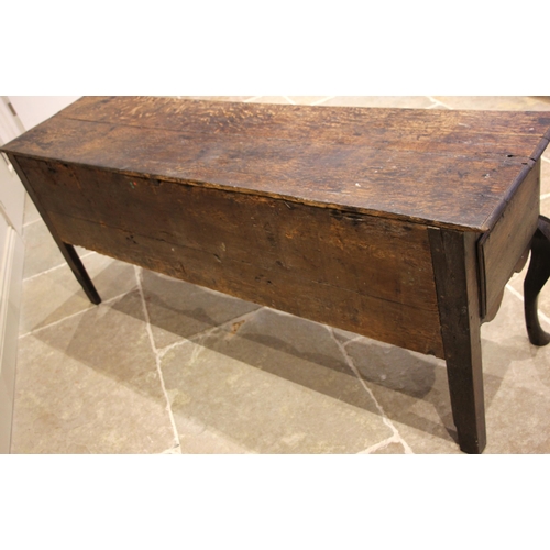 713 - An early 18th century oak Shropshire dresser base, the moulded twin plank top over three pine lined ... 