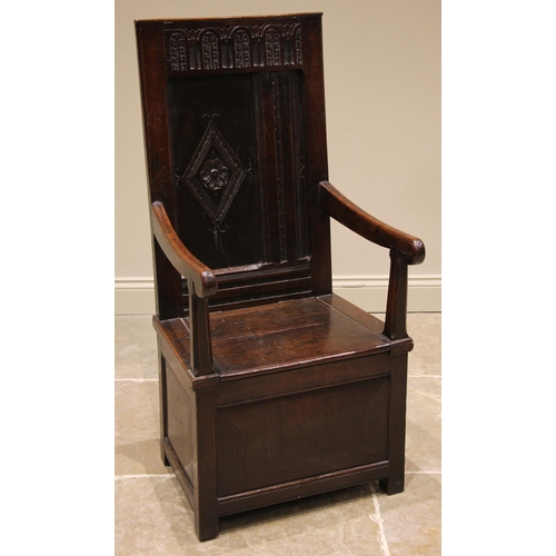 719 - An 18th century and later oak box seat Wainscot chair, the panelled back rest with a carved arcaded ... 