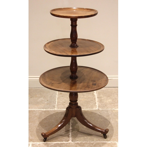 729 - A George III mahogany three tier dumb waiter, the three graduated circular tray tiers, upon ring tur... 