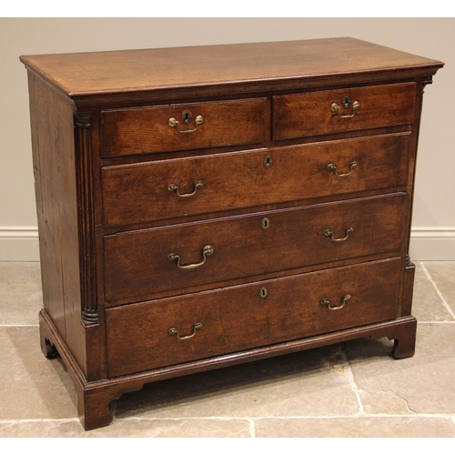 731 - A George III oak chest of drawers, the crossbanded top over an arrangement of two short and three gr... 