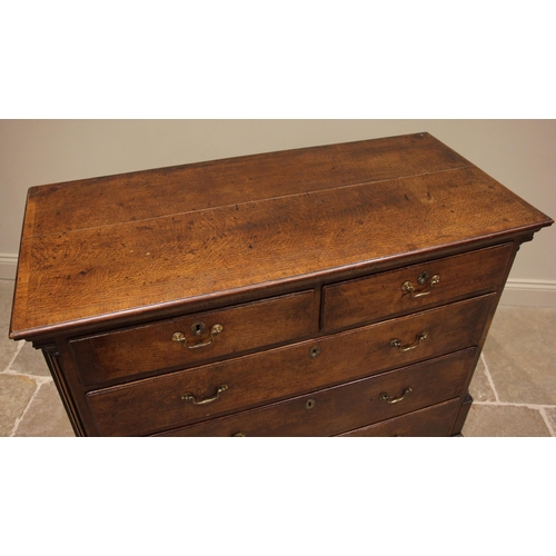 731 - A George III oak chest of drawers, the crossbanded top over an arrangement of two short and three gr... 