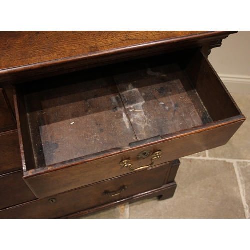 731 - A George III oak chest of drawers, the crossbanded top over an arrangement of two short and three gr... 