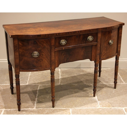 732 - A George III mahogany sideboard, of bowfront form, the central oak lined frieze drawer over a furthe... 