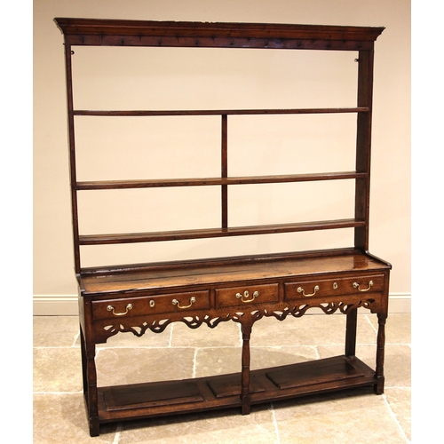 744 - A George III oak Welsh dresser, the moulded cornice and plain frieze applied with iron cup hooks ove... 