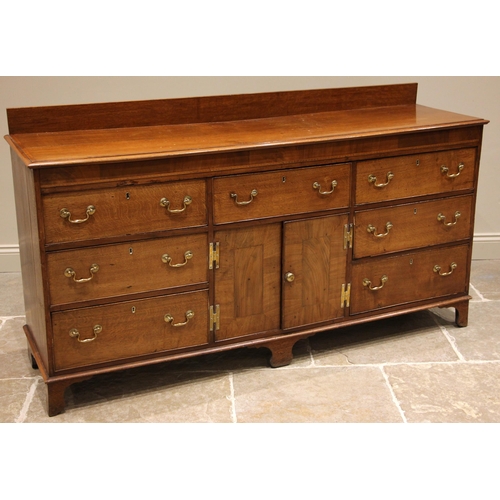 746 - A George III oak and mahogany crossbanded dresser base, the moulded top with a later rear gallery ov... 