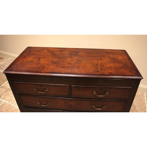 749 - A George III oak and mahogany crossbanded chest of drawers, formed with two over three lip moulded a... 