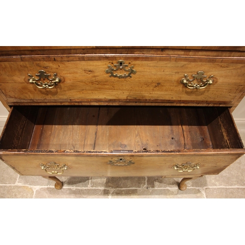 752 - A George I walnut chest on stand, the moulded cornice over an arrangement of two short and three gra... 