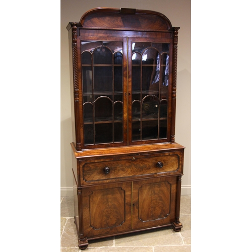 777 - A Regency mahogany secretaire bookcase, the arched pediment over a pair of arcaded astragal glazed d... 