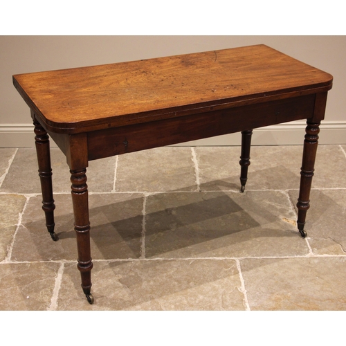 778 - A 19th century mahogany fold over side table, the rectangular folding top with rounded corners upon ... 