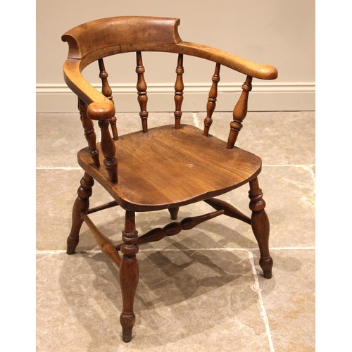 784 - A Victorian beech wood and ash captains elbow chair, with turned baluster spindles over the shaped s... 