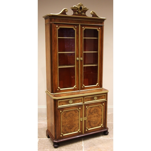 790 - A French walnut glazed bookcase/display cabinet, late 19th century, the gilt leafy crest flanked by ... 