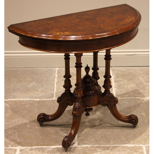 791 - A Victorian figured walnut fold-over card table, the demi lune moulded and book veneered top inlaid ... 