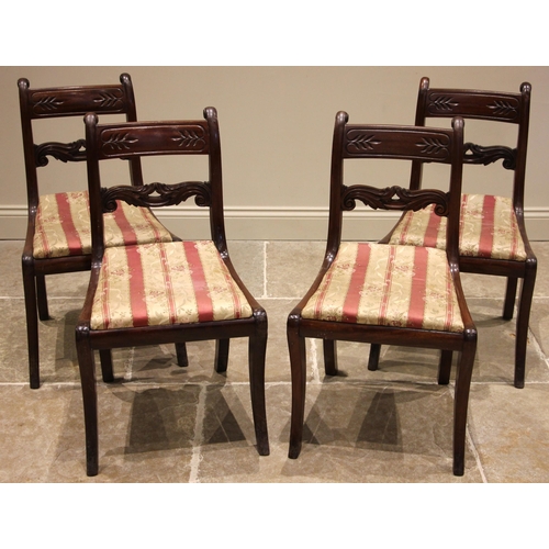 804 - A set of four Regency mahogany dining chairs, each with a rail back and leaf carved crest rail over ... 