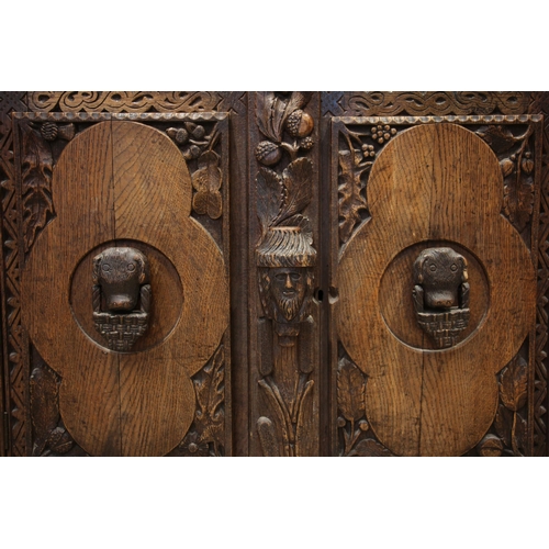 808 - A 19th century carved oak sideboard, probably Celtic, the cloud shaped rear gallery with a spire fin... 