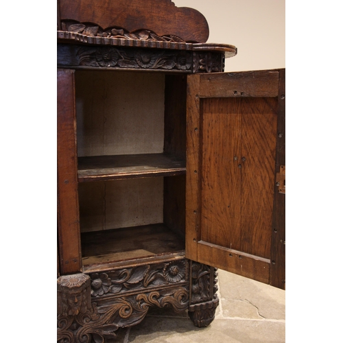 808 - A 19th century carved oak sideboard, probably Celtic, the cloud shaped rear gallery with a spire fin... 