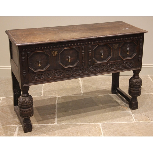 810 - A carved oak Jacobean revival dresser base, late 19th century, the moulded top over a pair of geomet... 