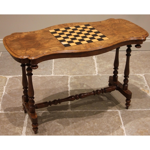 815 - A Victorian figured walnut games table, the book veneered serpentine top centred with an inlaid chec... 