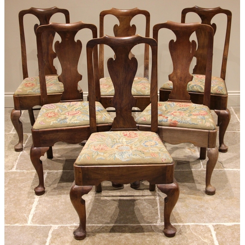 820 - A set of six walnut George II style dining chairs, each with a vase shaped splat over a drop-in tape... 