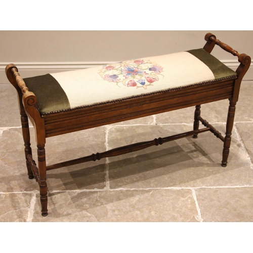 822 - An Edwardian walnut duet stool, the hinged tapestry work seat opening to twin compartments, flanked ... 