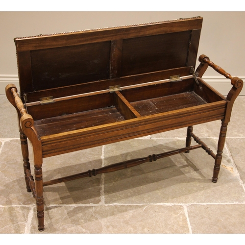 822 - An Edwardian walnut duet stool, the hinged tapestry work seat opening to twin compartments, flanked ... 