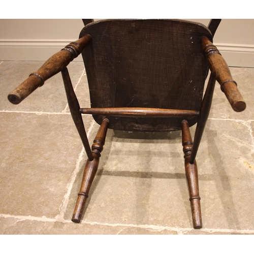 828 - A stained beech and elm wheelback Windsor elbow chair, 20th century, the hoop back over a shaped sea... 