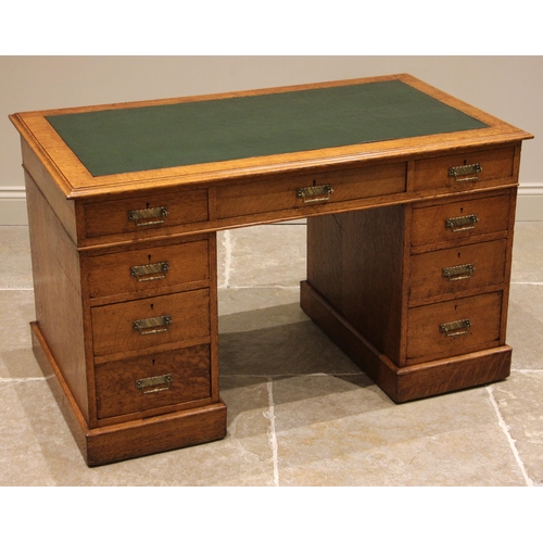 829 - An Edwardian oak twin pedestal desk, the moulded top with inset skiver over three ash lined frieze d... 