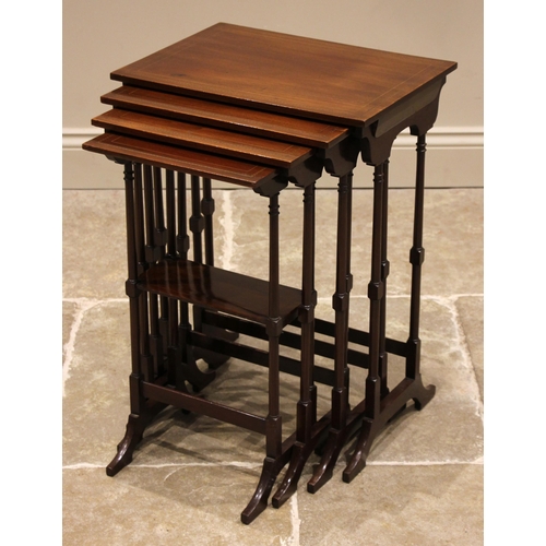 838 - An Edwardian mahogany quartetto nest of tables, the table tops outlined with chequered stringing, up... 