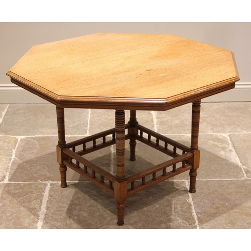 841 - An Edwardian oak octagonal library table, by Collinson and Lock, London, the moulded octagonal top u... 